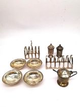 A collection of silver, including two toast racks, a conical design cruet set (hinge broken) and