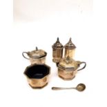 A silver five piece cruet set by Mappin & Webb, to include two mustard pots with blue glass