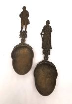 Two 19th century Dutch brass libation spoons with figurative finials and engraved detailing to the