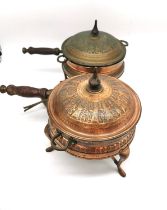 A pair of early 20th century Iranian Nader copper cooking pots with burners with figural design.