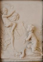 A moulded gold framed composite marble relief plaque of putti by 'P J Seymour', with bronze medal