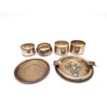 A collection of silver including, a silver ashtray with raised coat of arms, a silver coaster and