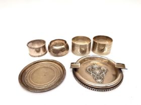 A collection of silver including, a silver ashtray with raised coat of arms, a silver coaster and