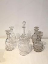 A collection of six hand cut glass and crystal decanters, including a pair of Georgian decanters