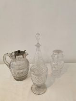 A cut glass decanter with wave pattern, a cut crystal and silver plate punch jug, a lead crystal