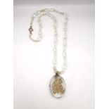 A Victorian rock crystal oval pendant with yellow metal (tests as higher than 9ct gold) seed pearl