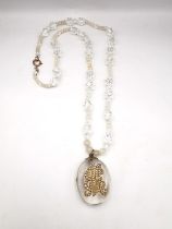 A Victorian rock crystal oval pendant with yellow metal (tests as higher than 9ct gold) seed pearl