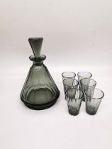 A Czechoslovakian Art Deco smoky faceted conical glass decanter with six matching shot glasses.