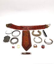 A miscellaneous collection to include two penknives, six carved bangles, a tribal beaded necklace, a
