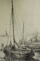 An etching of a moored sailing boat, framed and glazed. H.40 W.30cm.