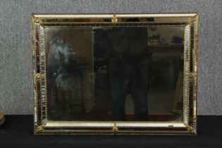 A wall mirror, with gilt metal decoration. H.59 W.80cm.