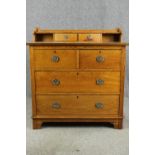 An Arts and Crafts oak dressing chest, with pewter handles, early 20th century. H.98 W.99 D.52cm.