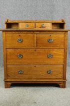 An Arts and Crafts oak dressing chest, with pewter handles, early 20th century. H.98 W.99 D.52cm.