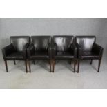 A set of four leatherette upholstered dining chairs.