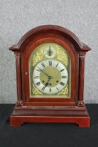 A walnut mantel clock in the Georgian style. H.42 W.34 D.20cm.