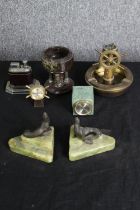 A pair of 1920s onyx and spelter bookends, in the form of seals, together with other small desk