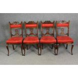 A set of four late Victorian walnut salon chairs in red damask upholstery