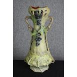 An Art Nouveau pottery vase, in the manner of Royal Dux, early 20th century. H.56cm.