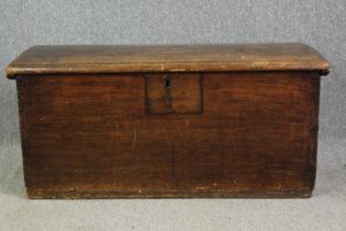 An antique hardwood lidded chest. H.57 W.120 D.55cm.