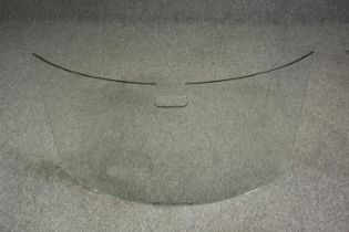 A modern curved glass fire screen. H.55 W.96cm.