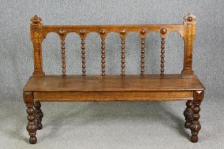 A Jacobean style bobbin turned oak bench seat, late 19th/early 20th century. H.97 W.134 D.37cm.
