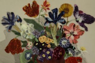 An embroidered still life of flowers, framed and glazed. H.59 W.64cm.