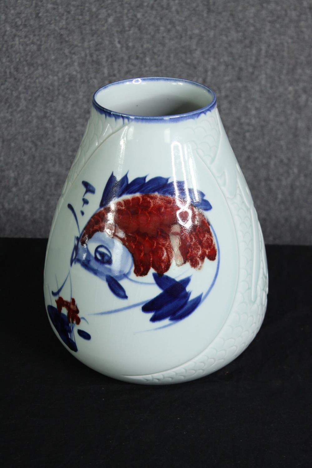 A large 20th century Japanese celadon glaze vase with stylised koi carp and incised scale texture,