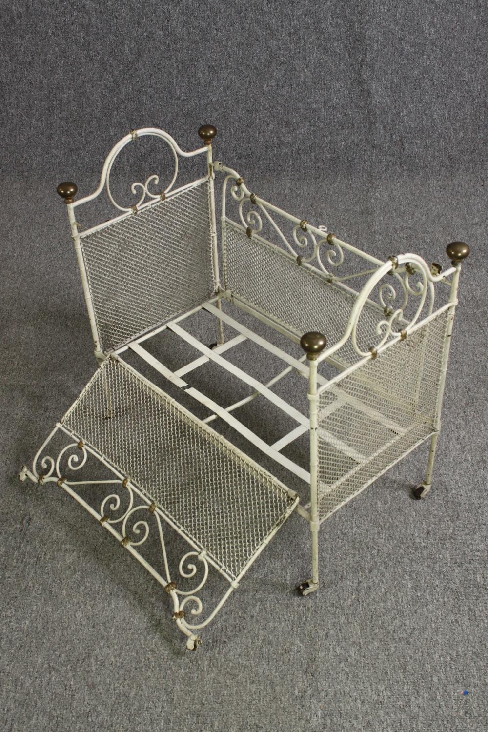 A white painted metal and brass cot, early 20th century. H.64 W.69 D.38cm. - Image 9 of 9