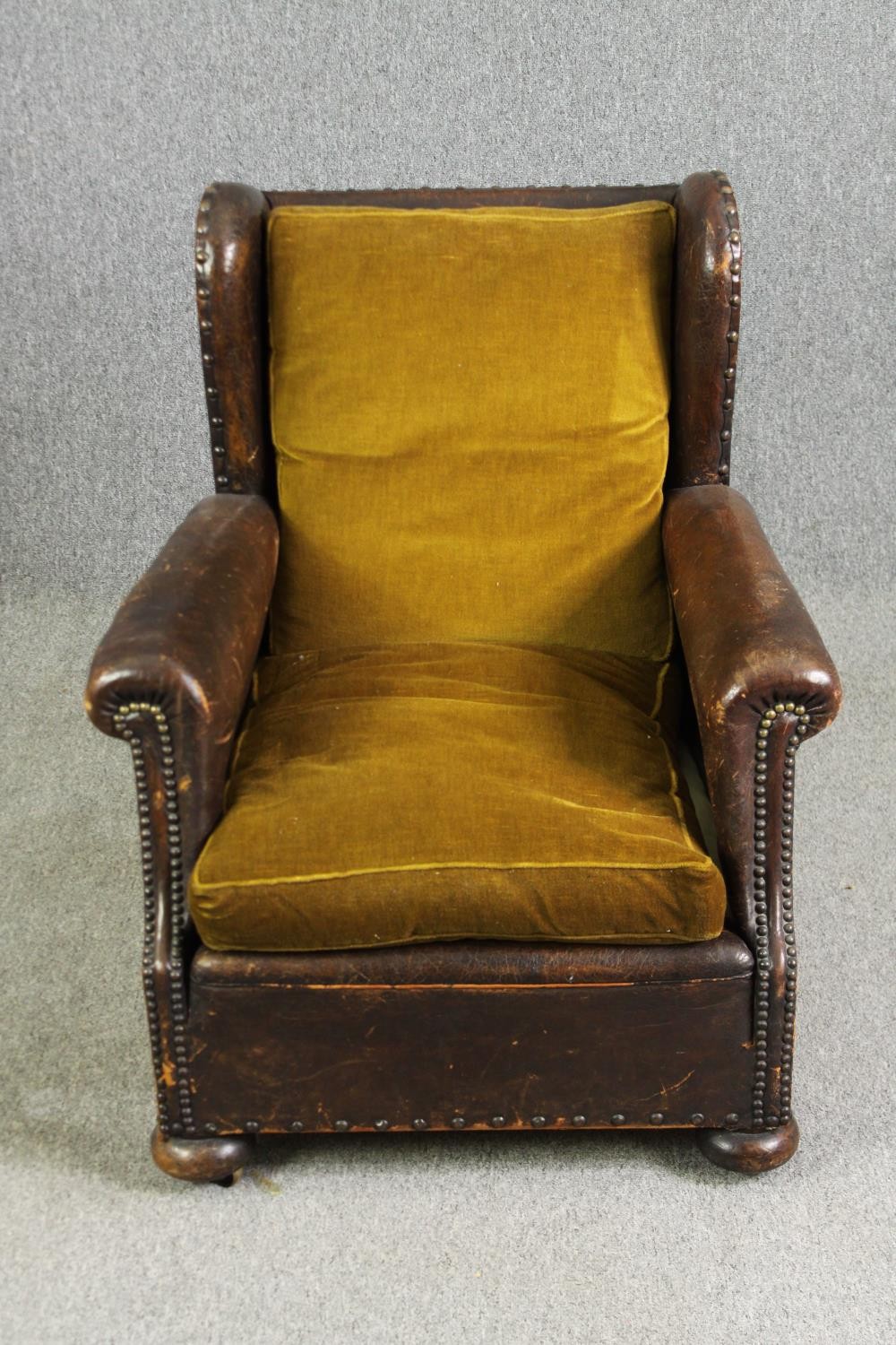 A leather and upholstered club chair. H.88 W.73 D.70cm, early 20th century.