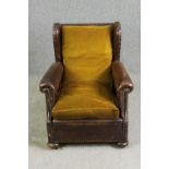 A leather and upholstered club chair. H.88 W.73 D.70cm, early 20th century.