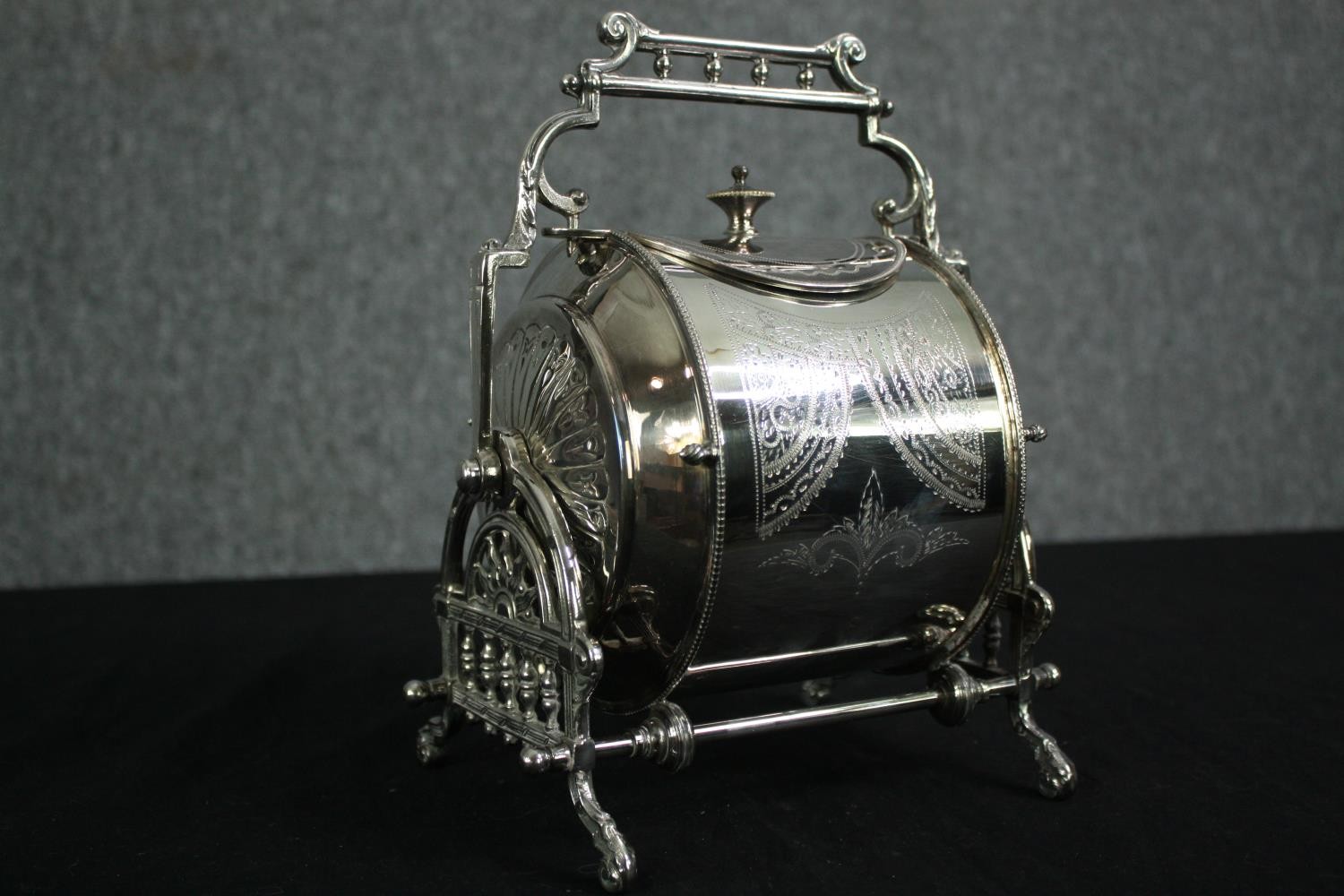 A 19th century silver plated biscuit barrel with engraved decoration, marked to the underside. H.