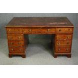 An early Victorian mahogany pedestal desk, with tooled red leather top and matching fitted leather