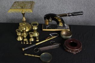 A group of small brass weights and other items. H.27cm. (largest).