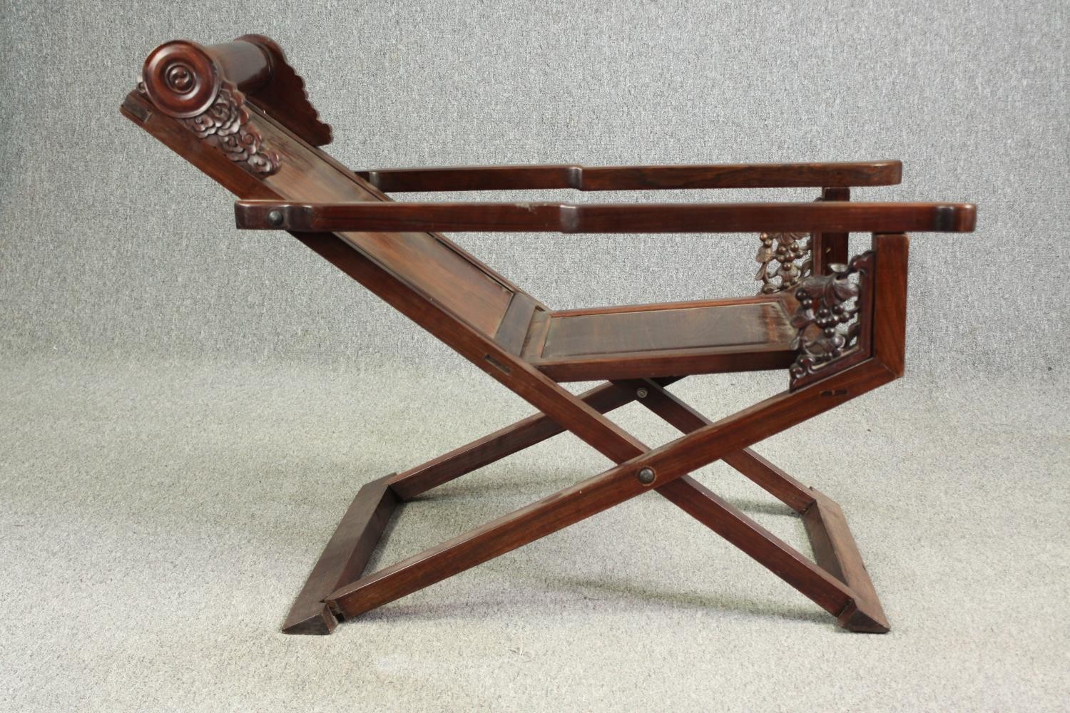 A Chinese carved hardwood folding chair, 19th century. H.78 W.112 D.59cm. - Image 4 of 12