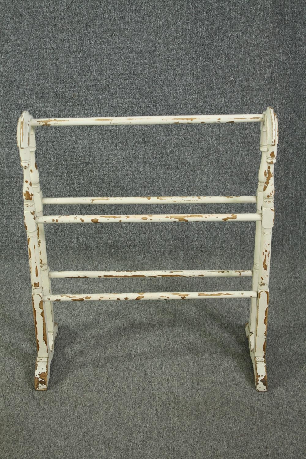 A Victorian distressed white painted towel rail. H.80 W.67 D.16cm.