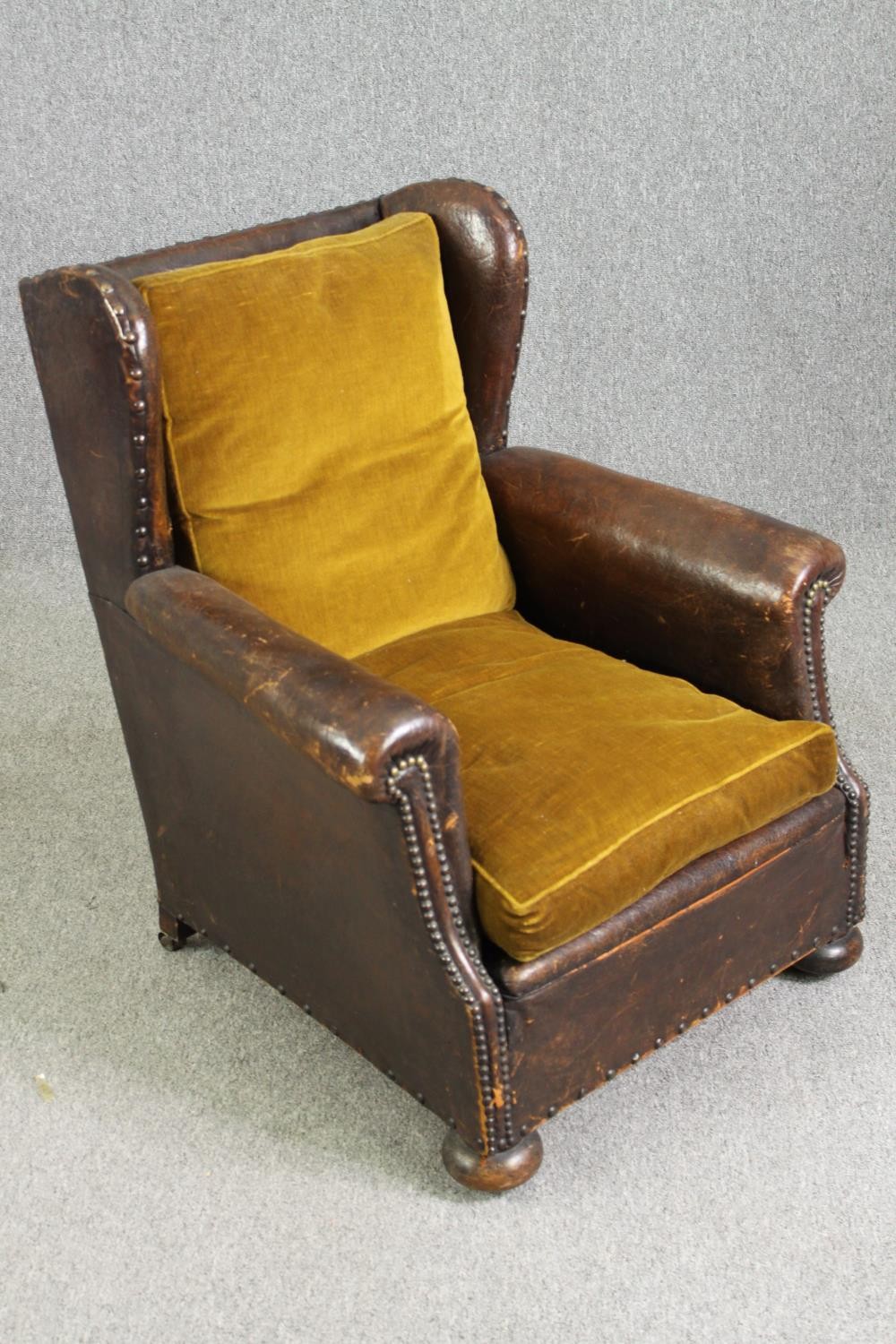 A leather and upholstered club chair. H.88 W.73 D.70cm, early 20th century. - Image 2 of 6