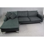 A contemporary grey upholstered corner sofa with chrome supports, H.80 W.246 D.150cm.
