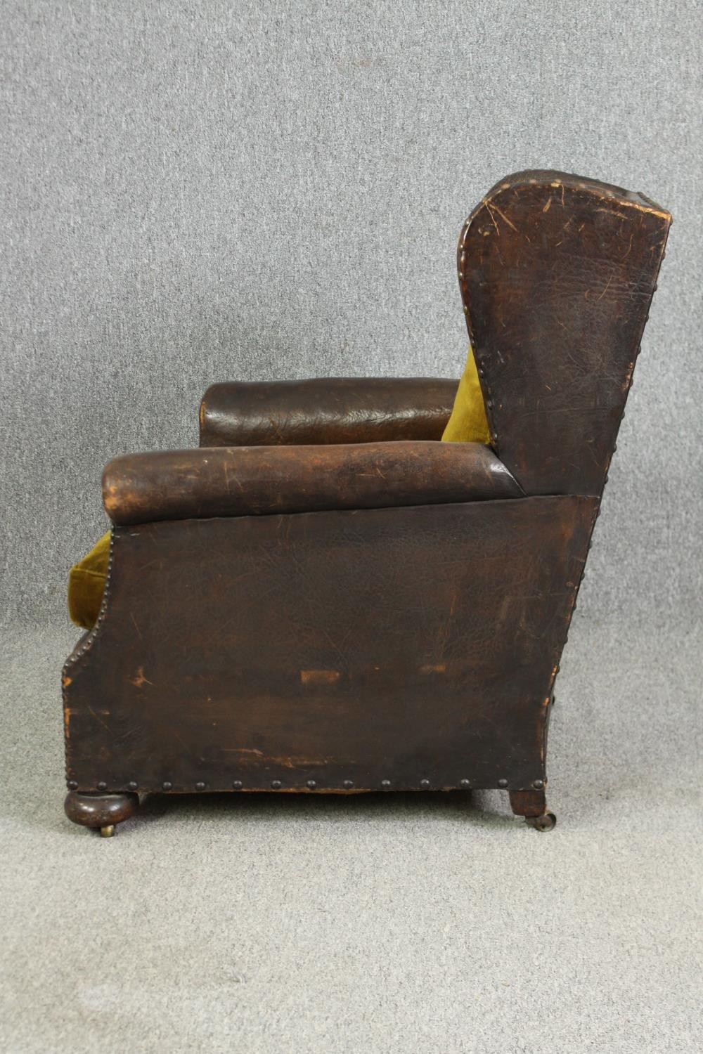 A leather and upholstered club chair. H.88 W.73 D.70cm, early 20th century. - Image 4 of 6