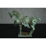 A Chinese Tang style bronzed metal model of a horse, with verdigris patination. H.22cm.