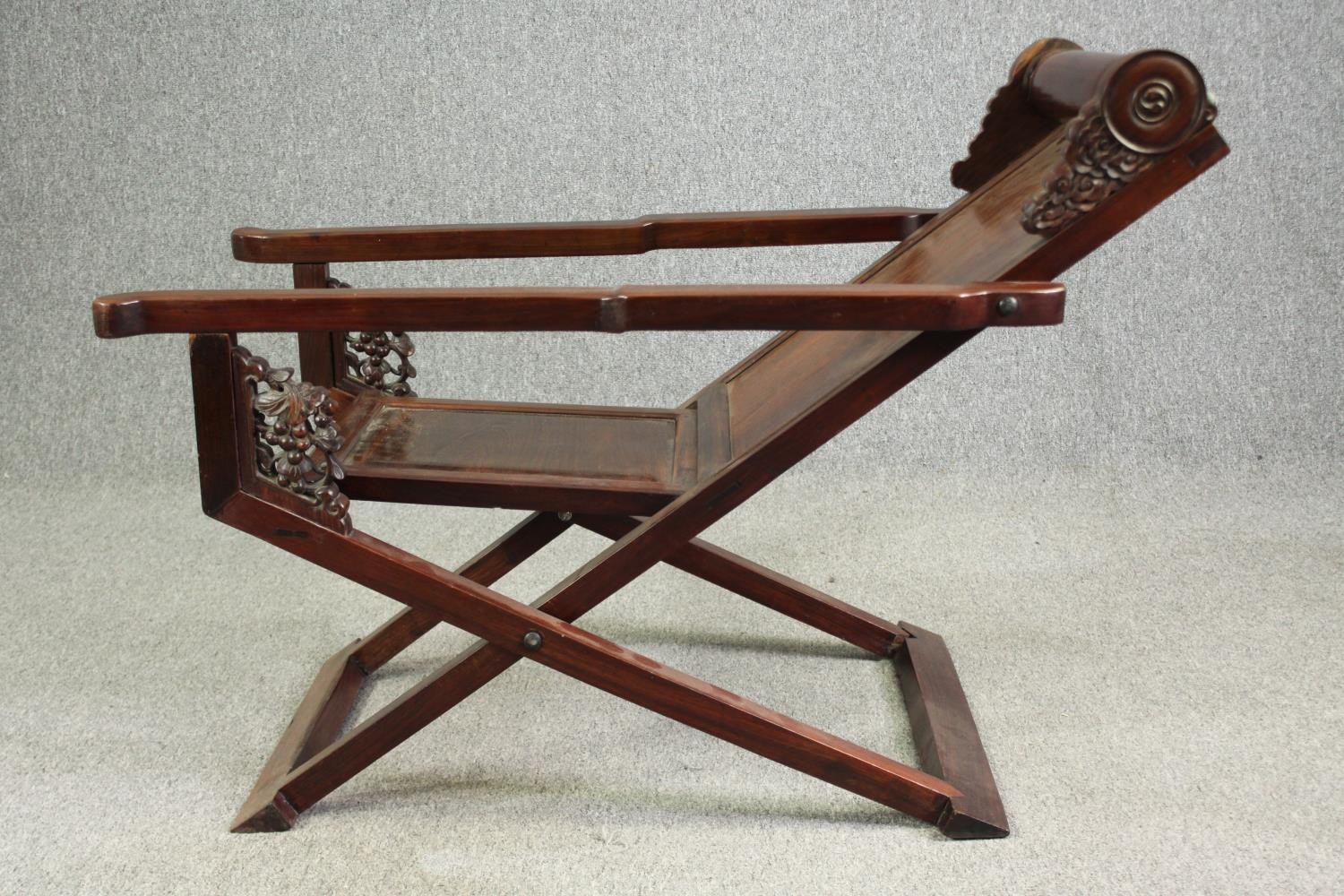 A Chinese carved hardwood folding chair, 19th century. H.78 W.112 D.59cm. - Image 9 of 12