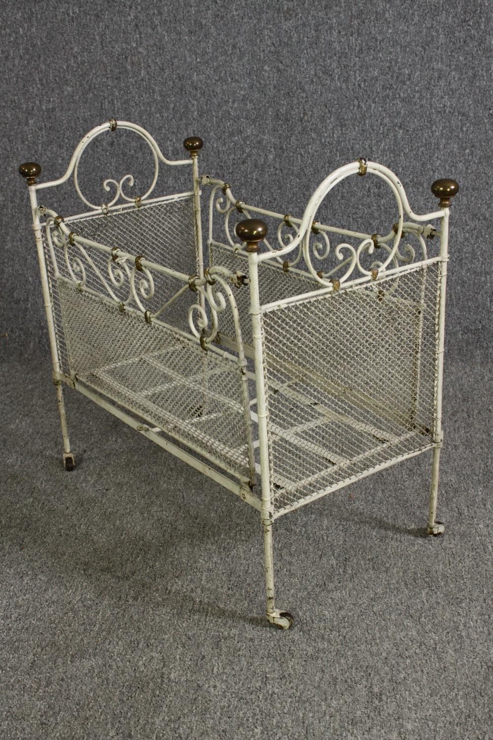 A white painted metal and brass cot, early 20th century. H.64 W.69 D.38cm. - Image 4 of 9