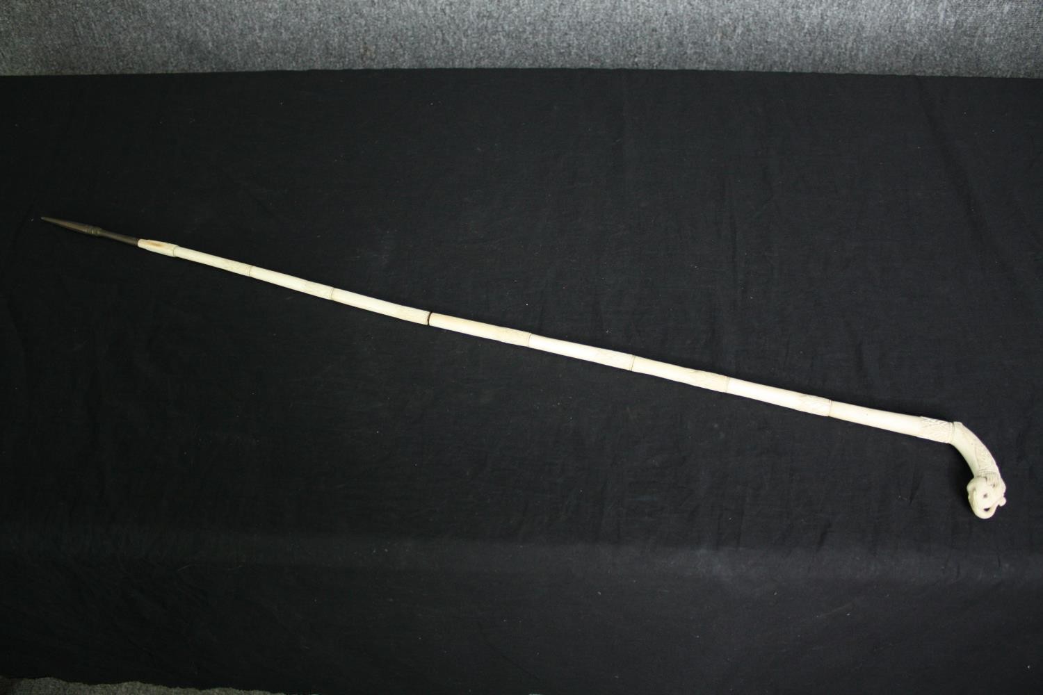 An Indian carved bone walking stick. L.90cm.