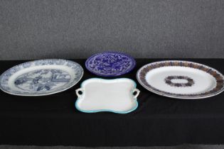 A group of four various porcelain serving plates. L.51 W.42cm. (largest).