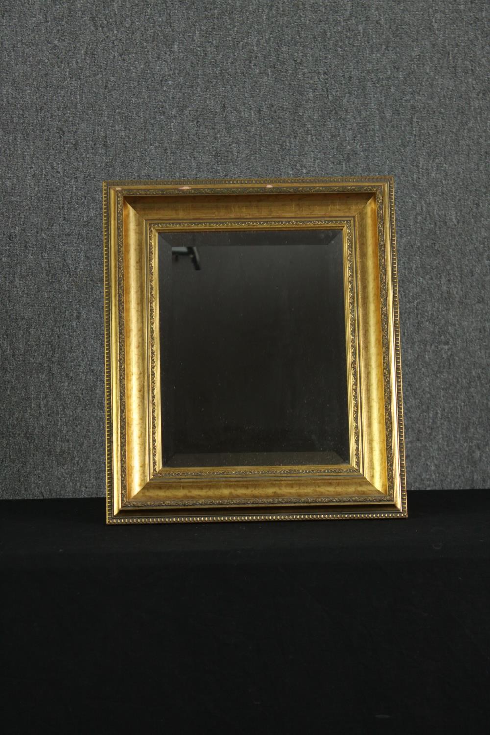 A giltwood wall mirror. H.50 W.42cm.