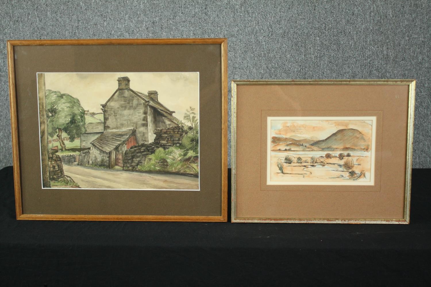 A watercolour of a cottage and another sepia landscape, both framed and glazed. H.40 W.47cm. (