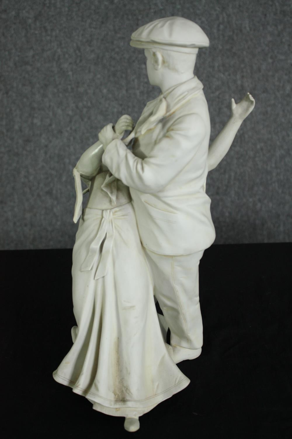 A white bisque porcelain figural group of an early 20th century man and woman dancing. H.39cm. - Image 3 of 7