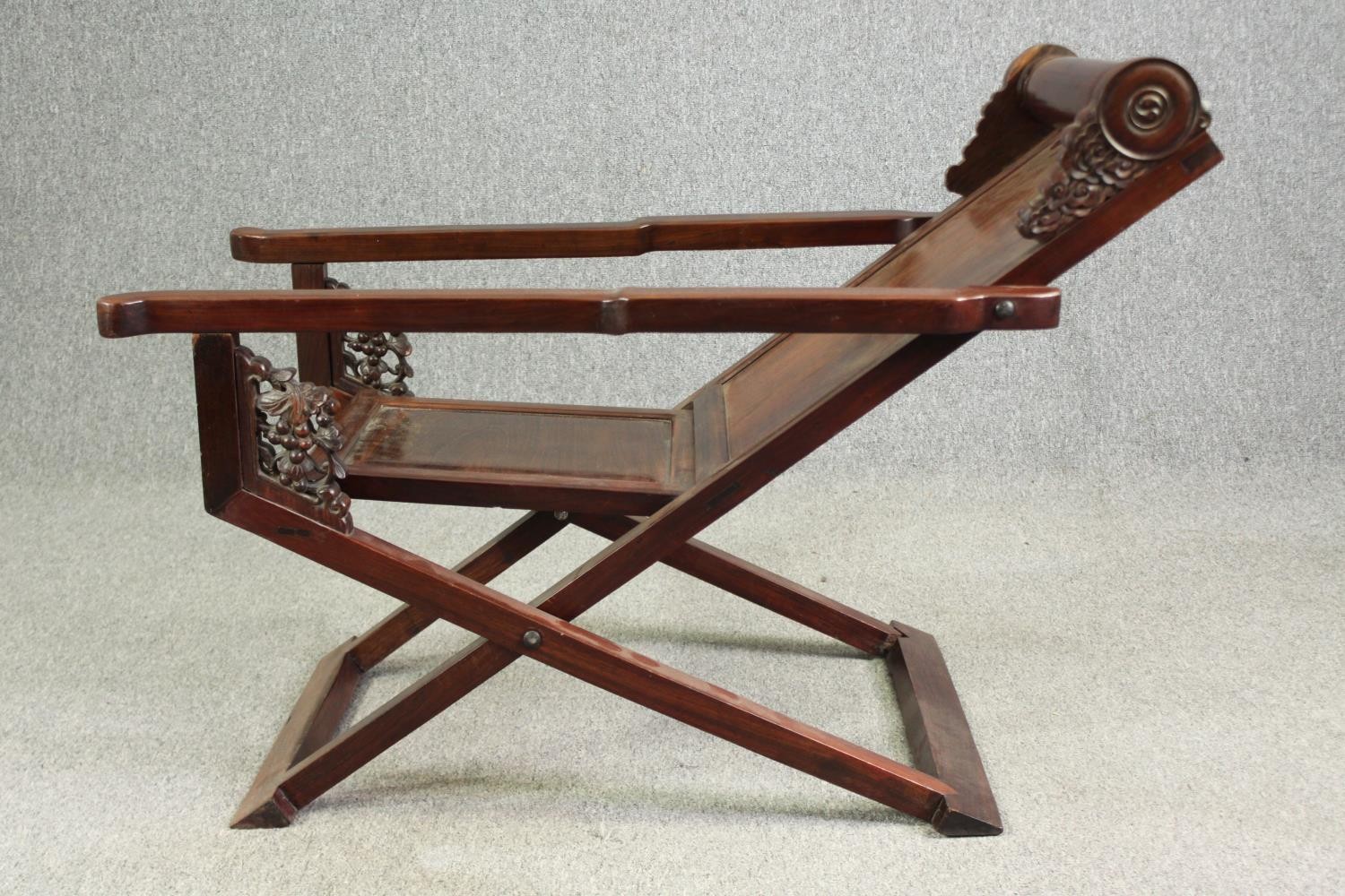 A Chinese carved hardwood folding chair, 19th century. H.78 W.112 D.59cm. - Image 8 of 12