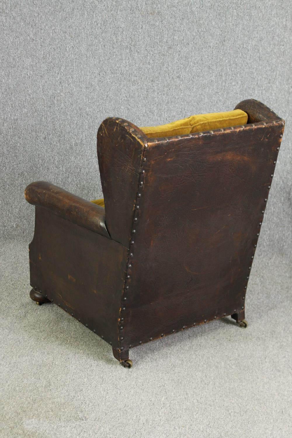 A leather and upholstered club chair. H.88 W.73 D.70cm, early 20th century. - Image 5 of 6