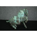 A Chinese Tang style bronzed metal model of a horse, with verdigris patination. H.21cm.