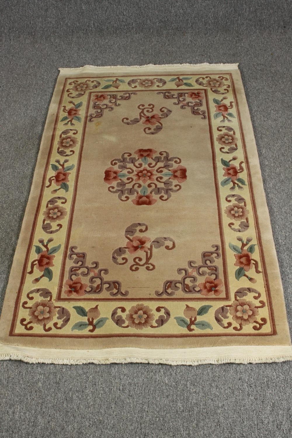 A Chinese style rug, with beige ground. L.163 W.92cm.